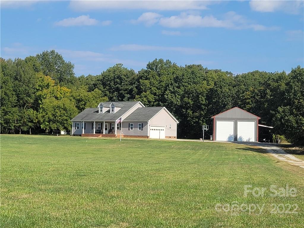 6925 Medlin Road Monroe, NC 28112 - Photo 37 of 41 a front view of a house with a yard and trees