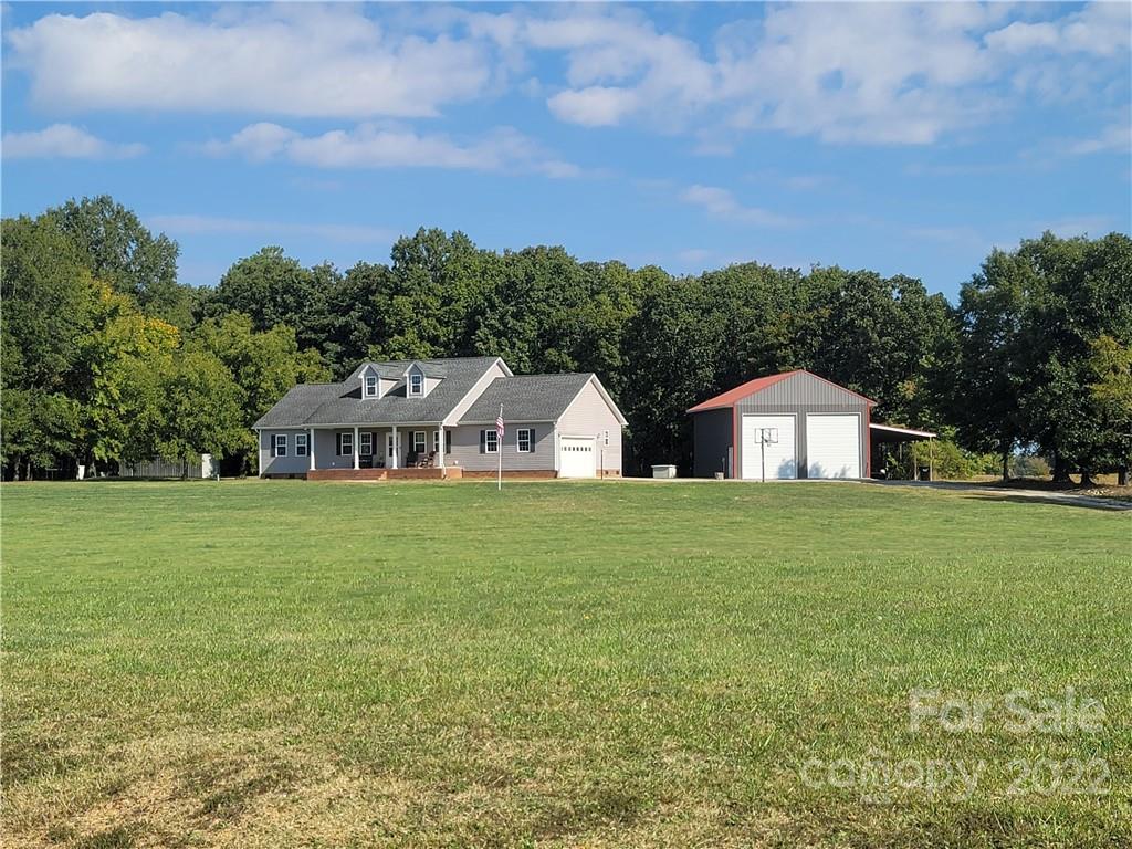 6925 Medlin Road Monroe, NC 28112 - Photo 39 of 41 a front view of a house with a yard