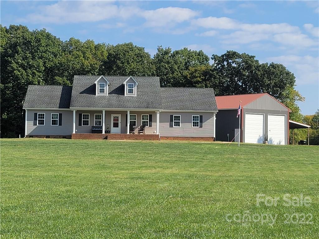 6925 Medlin Road Monroe, NC 28112 - Photo 40 of 41 a front view of a house with a garden