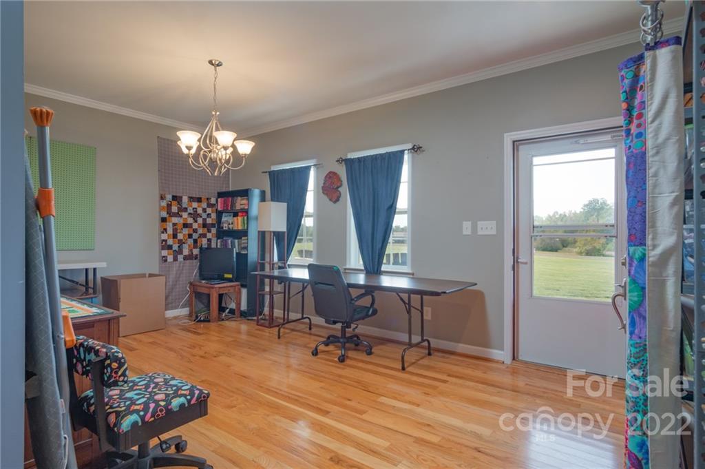 6925 Medlin Road Monroe, NC 28112 - Photo 6 of 41 a view of a dining room with furniture window and wooden floor