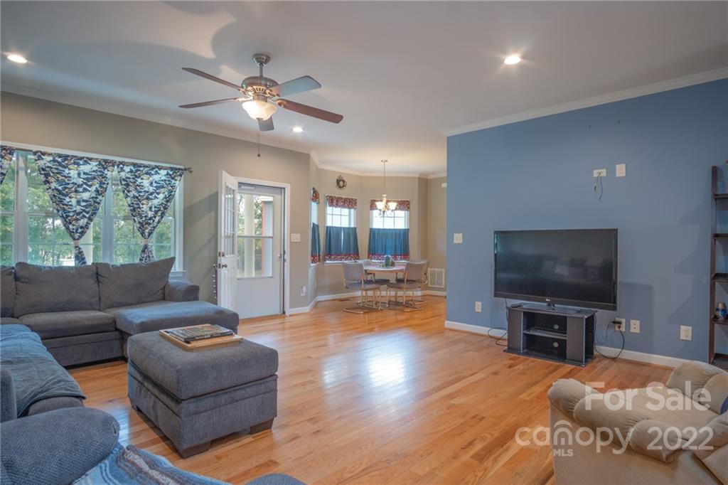 6925 Medlin Road Monroe, NC 28112 - Photo 8 of 41 a living room with furniture and a flat screen tv