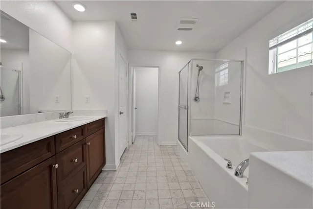 a spacious bathroom with a granite countertop sink mirror bathtub and shower