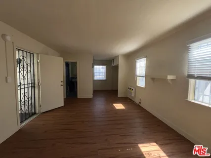 a view of wooden floor and windows in an empty room