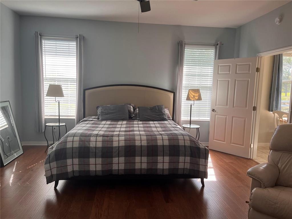 8908 Southwest 84th Circle Ocala, FL 34481 - Photo 12 of 24 a bedroom with a bed and wooden floor