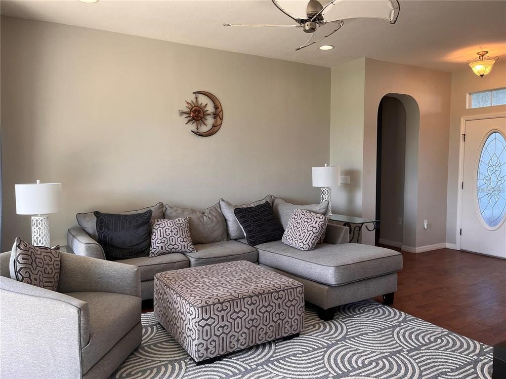 8908 Southwest 84th Circle Ocala, FL 34481 - Photo 16 of 24 a living room with furniture and a rug