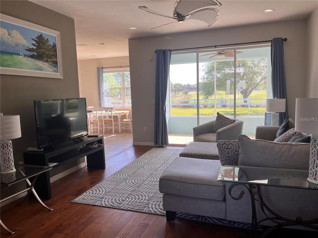8908 Southwest 84th Circle Ocala, FL 34481 - Photo 2 of 24 a living room with furniture and a flat screen tv