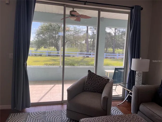a living room with a large window and a table