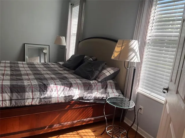 a bedroom with a bed and glass windows