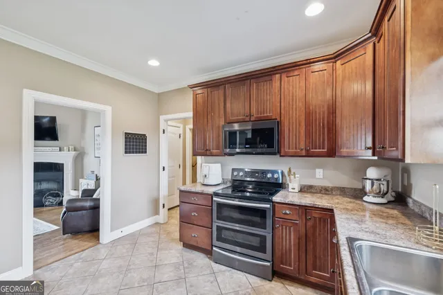 a kitchen with stainless steel appliances granite countertop a refrigerator stove and sink