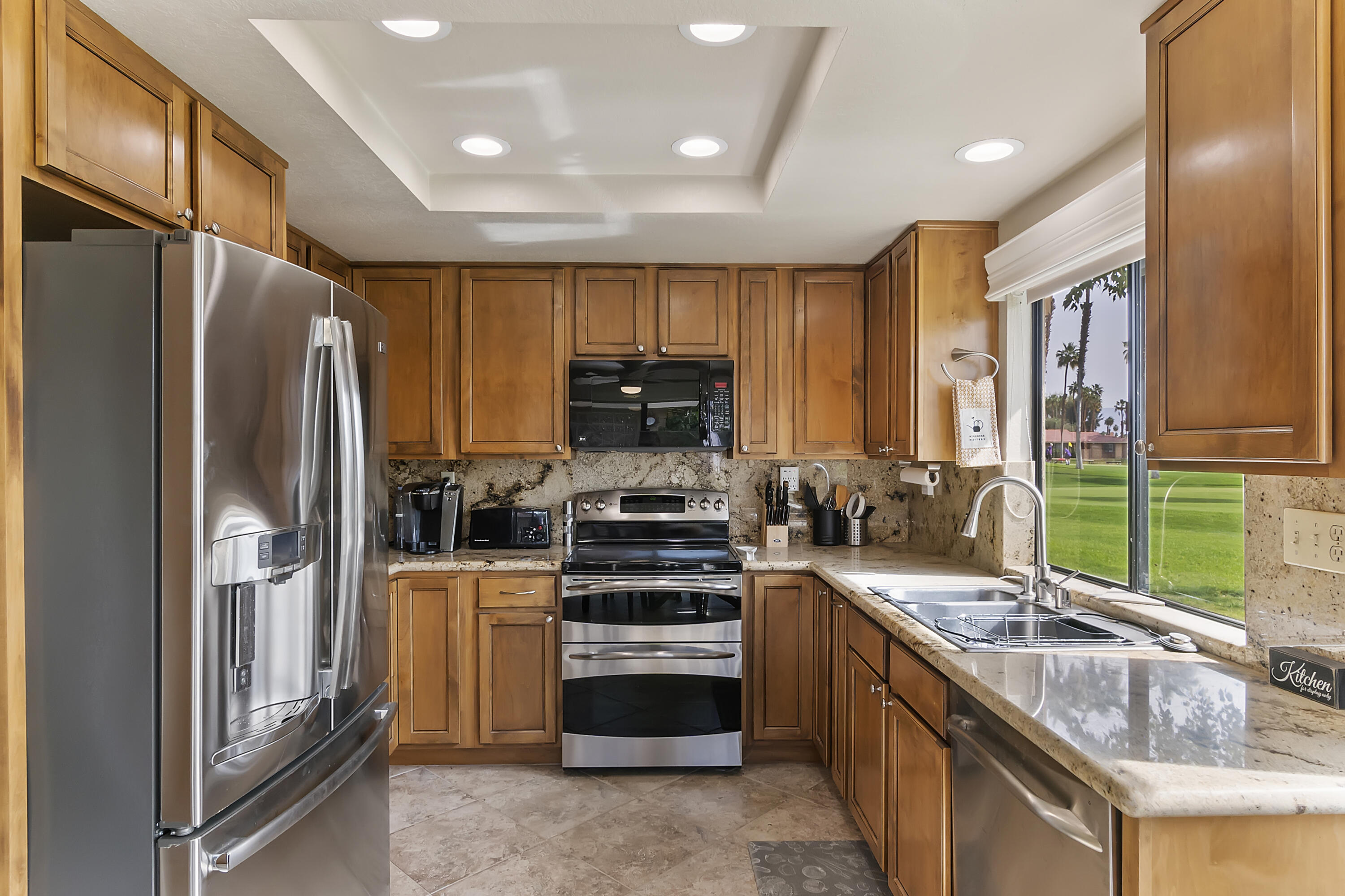 6 Maximo Way Palm Desert, CA 92260 - Photo 11 of 48 a kitchen with stainless steel appliances a stove sink and refrigerator