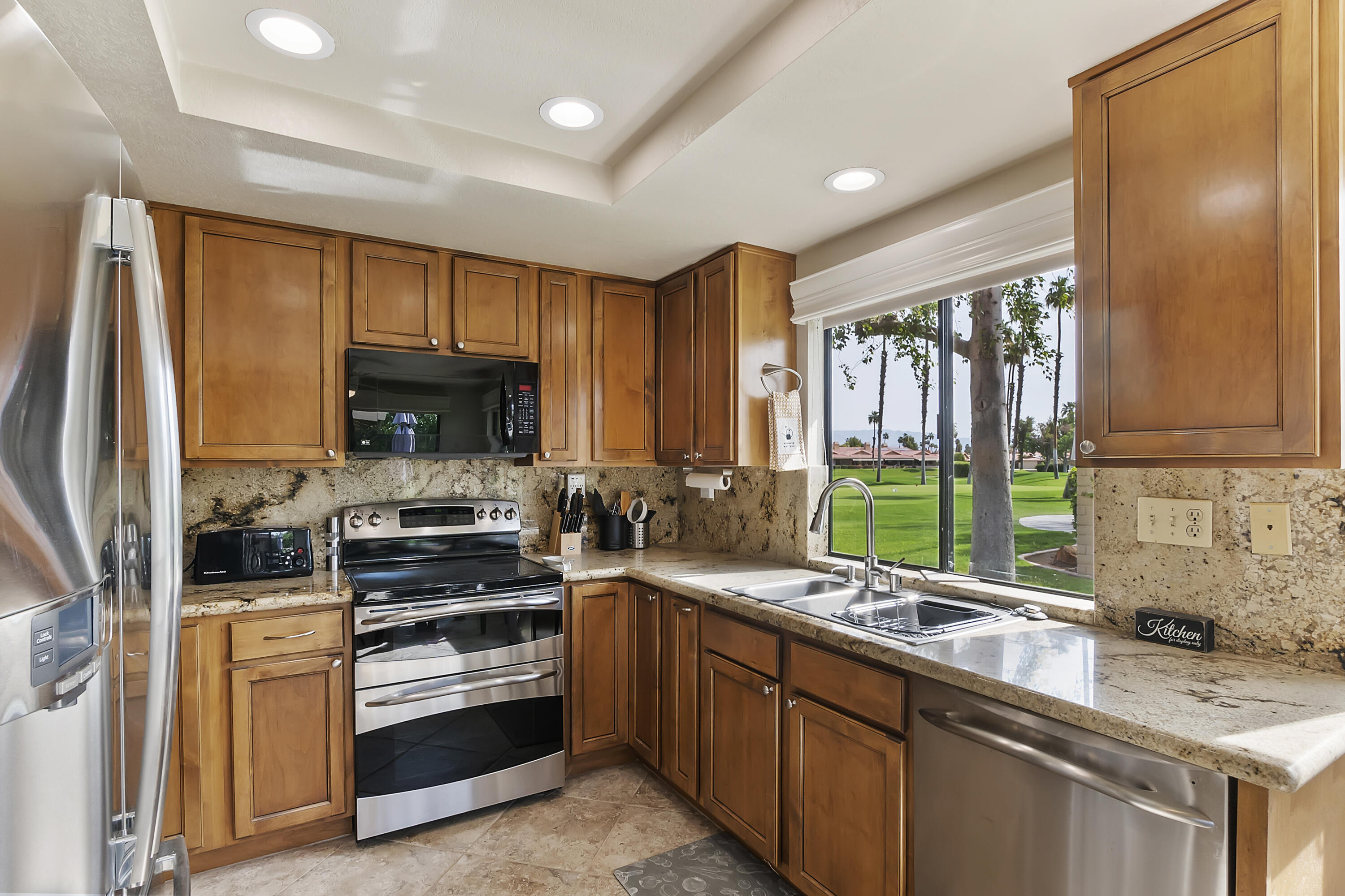6 Maximo Way Palm Desert, CA 92260 - Photo 2 of 48 a kitchen with stainless steel appliances a sink stove and cabinets