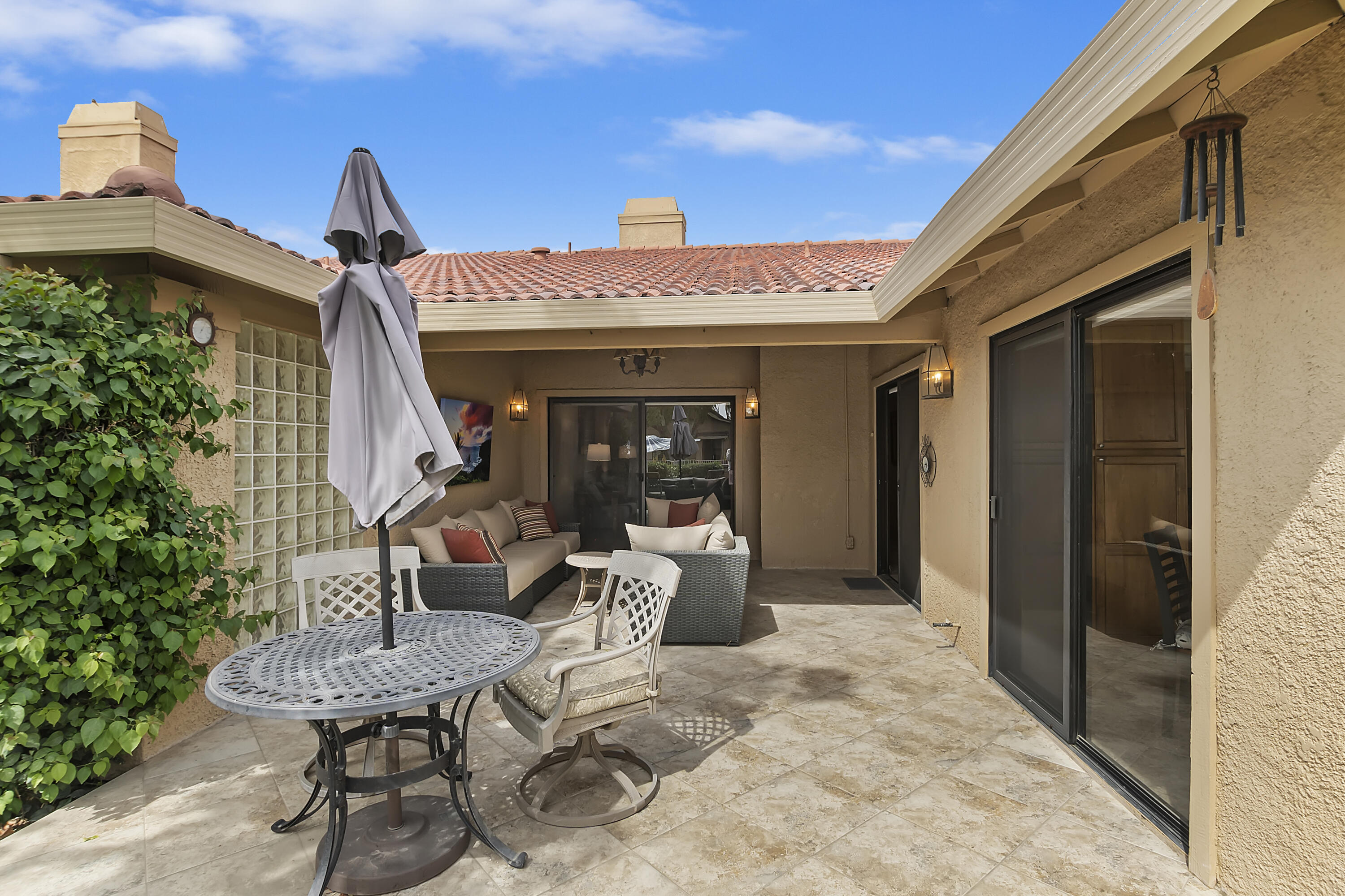 6 Maximo Way Palm Desert, CA 92260 - Photo 26 of 48 a view of a patio with table and chairs and potted plants