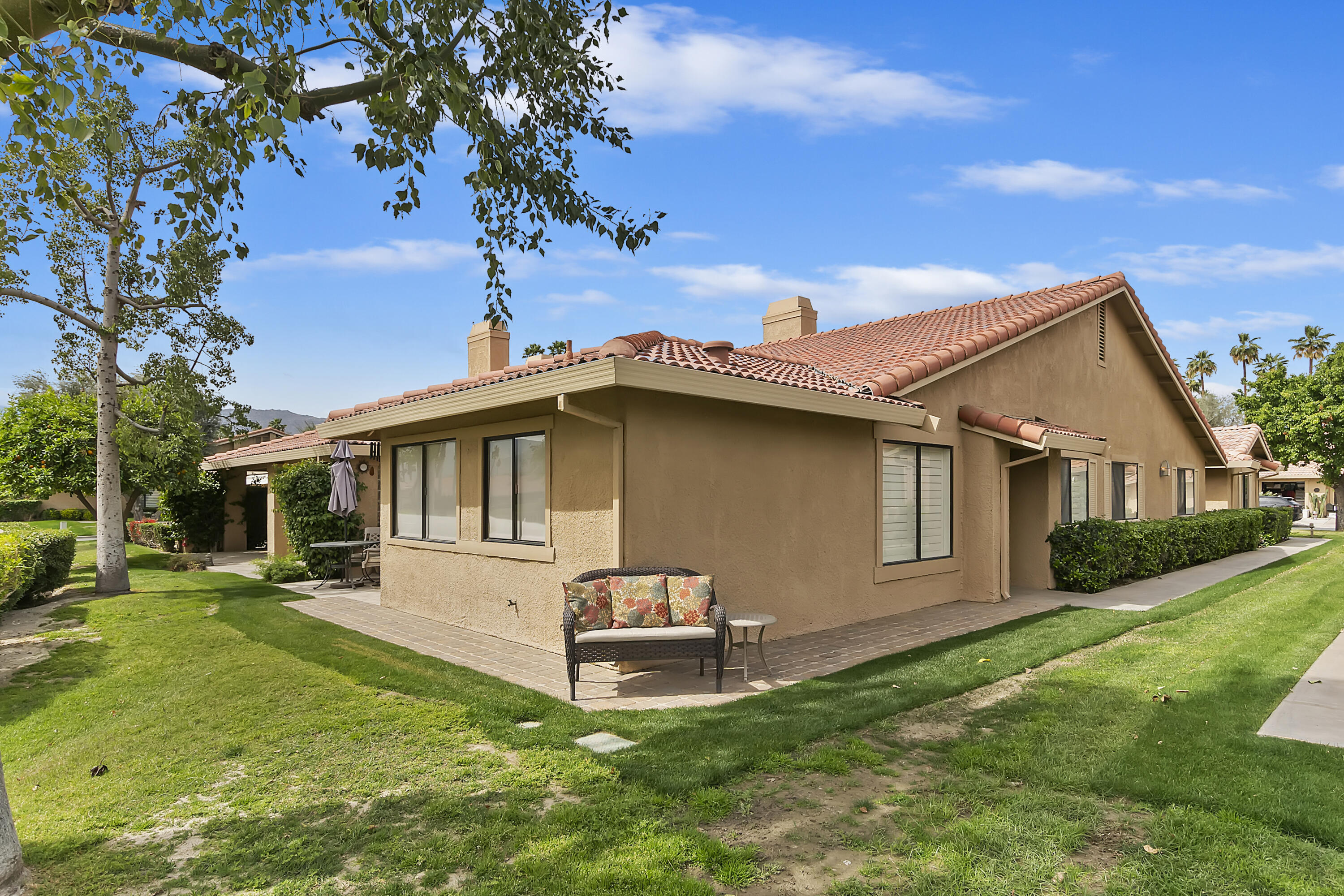 6 Maximo Way Palm Desert, CA 92260 - Photo 30 of 48 a front view of a house with a garden