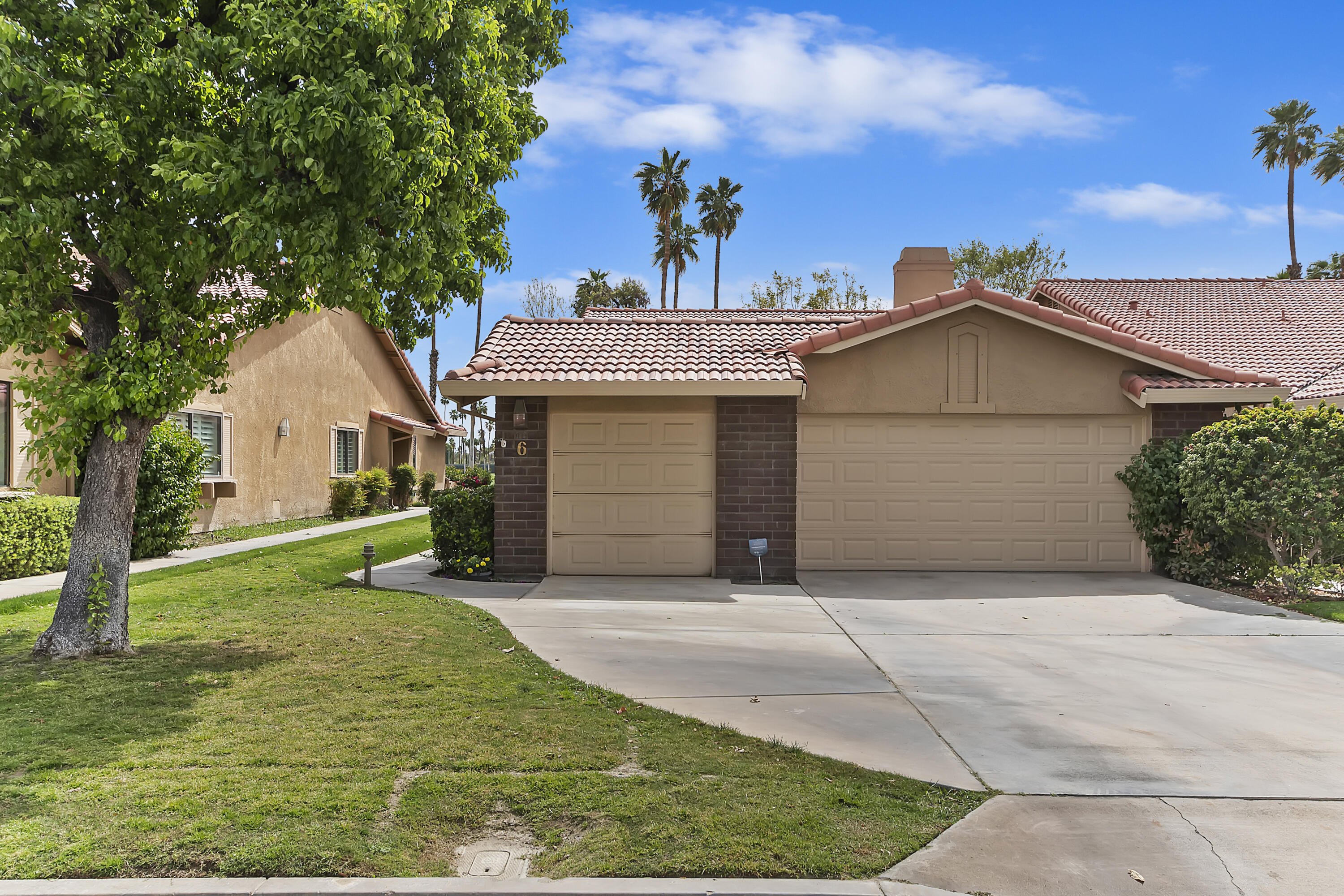 6 Maximo Way Palm Desert, CA 92260 - Photo 32 of 48 a front view of a house with a yard and garage