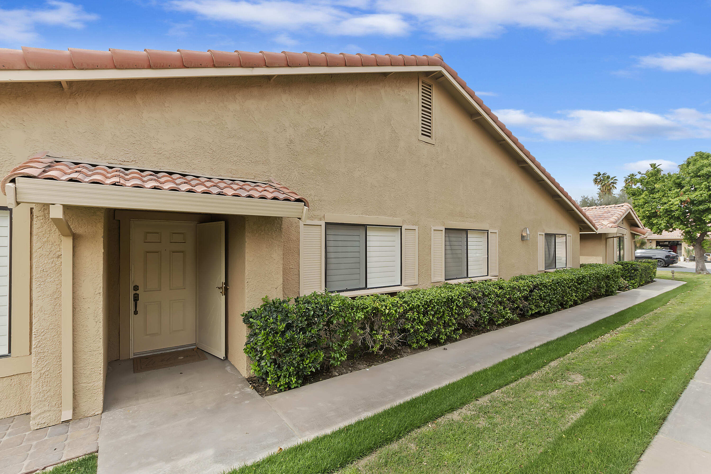 6 Maximo Way Palm Desert, CA 92260 - Photo 33 of 48 a front view of a house with a yard