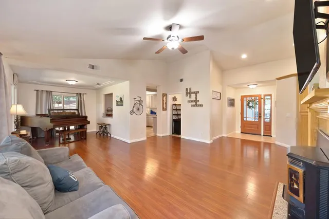 a kitchen with stainless steel appliances granite countertop a sink dishwasher a refrigerator a stove with island and cabinets