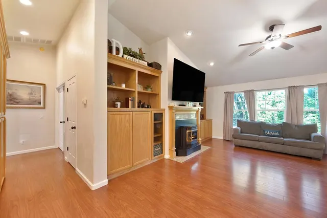 a kitchen with stainless steel appliances granite countertop a sink refrigerator and cabinets