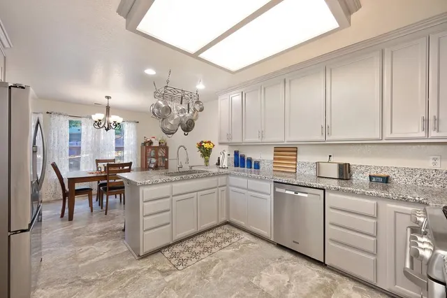 a bedroom with a large bed and a flat tv screen on dresser