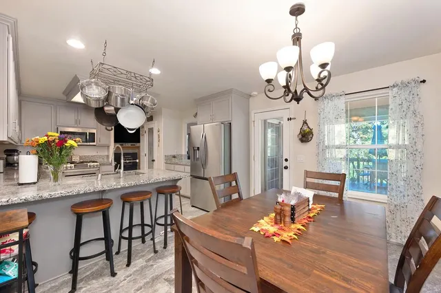 a bathroom with a sink a toilet a mirror and shower curtain