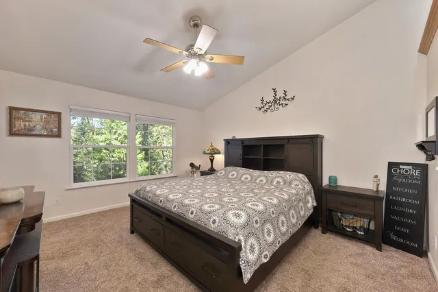 a spacious bedroom with a bed and a chandelier