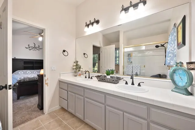 a view of a house with a yard and large trees