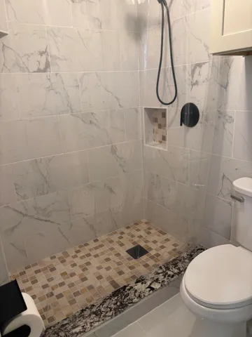 a bathroom with a toilet and shower