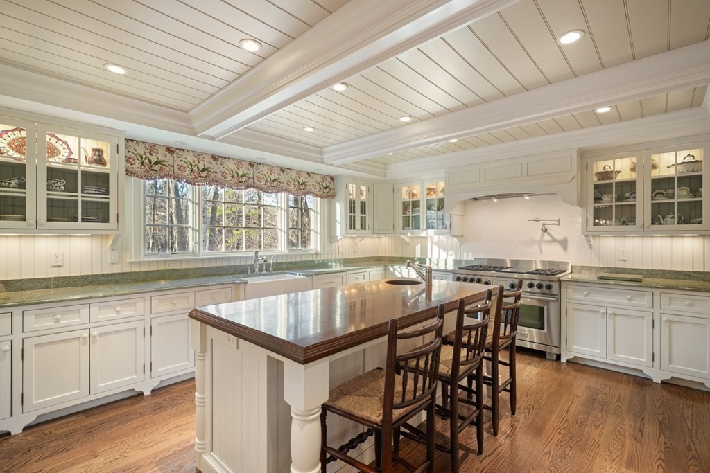 111 Livingston Road Wellesley, MA 02482 - Photo 16 of 42 a kitchen with a table chairs stove and cabinets
