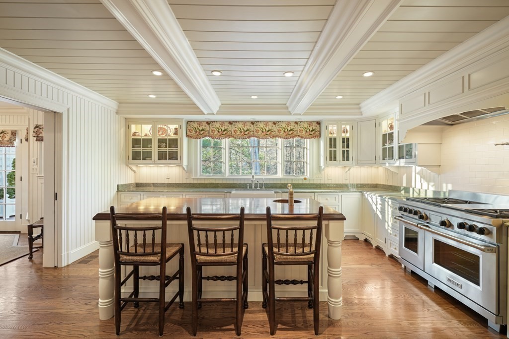 111 Livingston Road Wellesley, MA 02482 - Photo 17 of 42 a kitchen with stainless steel appliances a stove a sink a dining table and chairs