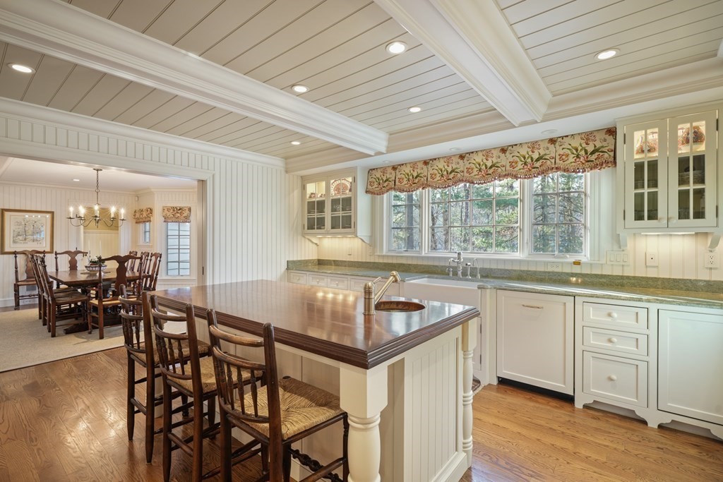111 Livingston Road Wellesley, MA 02482 - Photo 18 of 42 a kitchen with granite countertop a table chairs stove and wooden floor