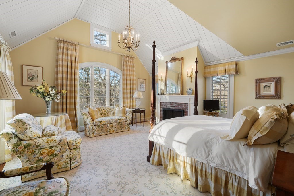 111 Livingston Road Wellesley, MA 02482 - Photo 30 of 42 a spacious bedroom with a bed and a chandelier