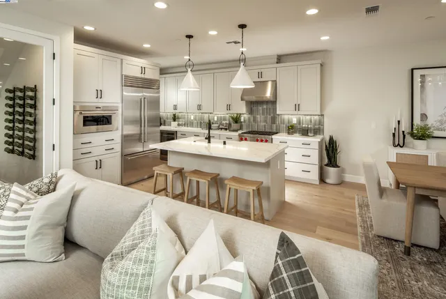 a large kitchen with stainless steel appliances kitchen island granite countertop a sink and cabinets