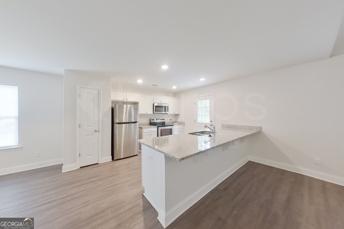 231 Western Red Cedar Drive Springfield, GA 31329 - Photo 7 of 26 a kitchen with a sink cabinets and wooden floor