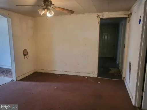 an empty room with a empty space and a ceiling fan