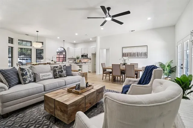 a living room with furniture and a potted plant
