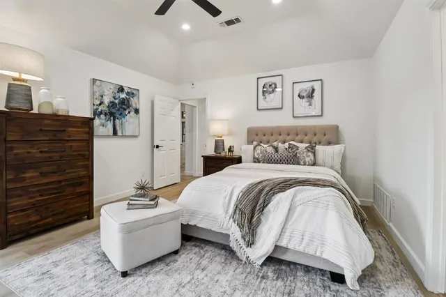 a spacious bedroom with a bed and glass door