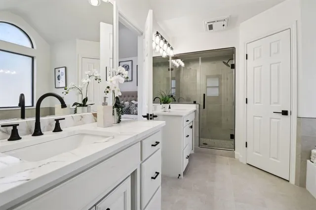 a bathroom with a tub sink and mirror