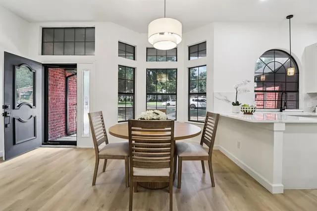 a view of a dining room with furniture window and wooden floor