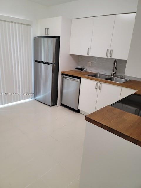 3490 Atlanta Street, Unit B Hollywood, FL 33021 - Photo 1 of 21 a kitchen with a refrigerator and a stove top oven