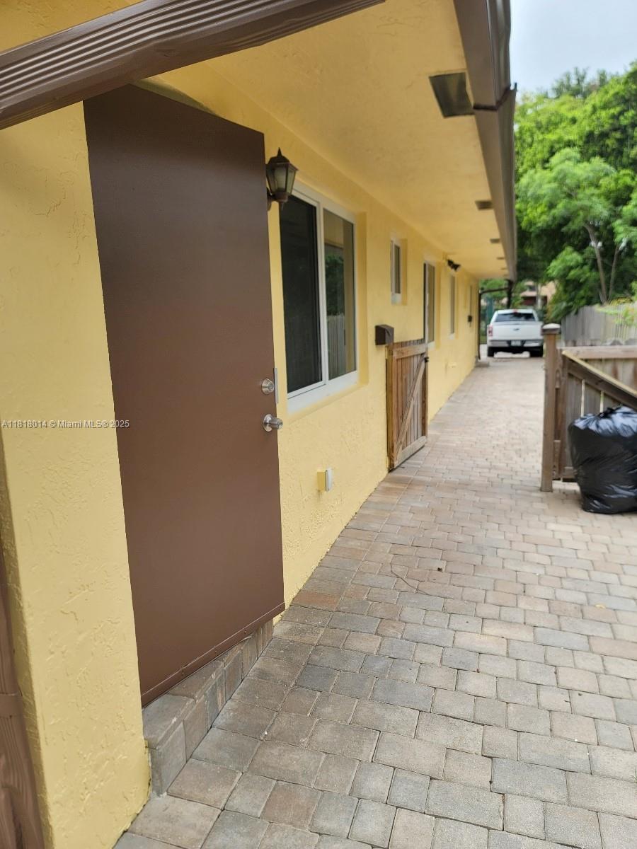 3490 Atlanta Street, Unit B Hollywood, FL 33021 - Photo 19 of 21 a view of a patio with table and chairs and potted plants