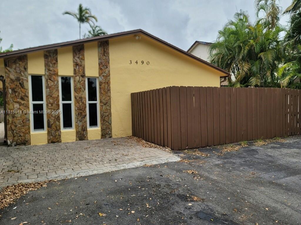 3490 Atlanta Street, Unit B Hollywood, FL 33021 - Photo 4 of 21 a view of backyard with door and wooden fence