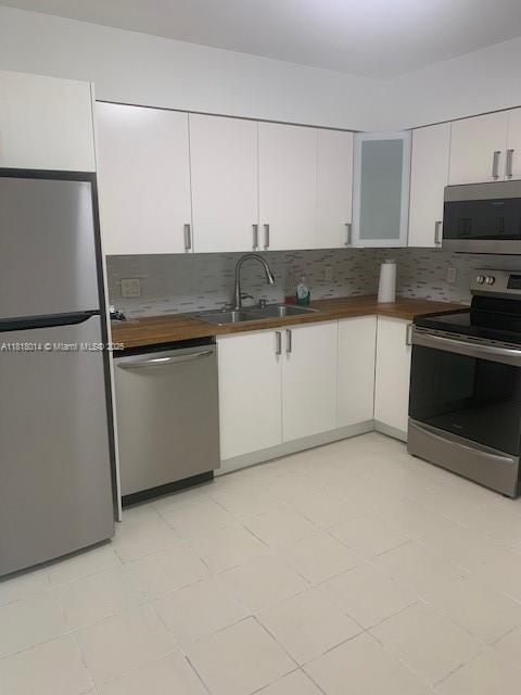 3490 Atlanta Street, Unit B Hollywood, FL 33021 - Photo 5 of 21 a kitchen with granite countertop white cabinets and white appliances