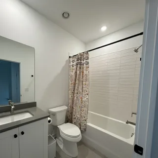 a bathroom with a sink toilet and shower