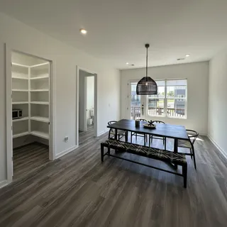 a bedroom with furniture and wooden floor