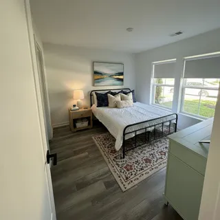 a bedroom with a bed and wooden floor