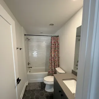 a bathroom with a sink toilet and shower