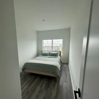 a bedroom with a bed and window