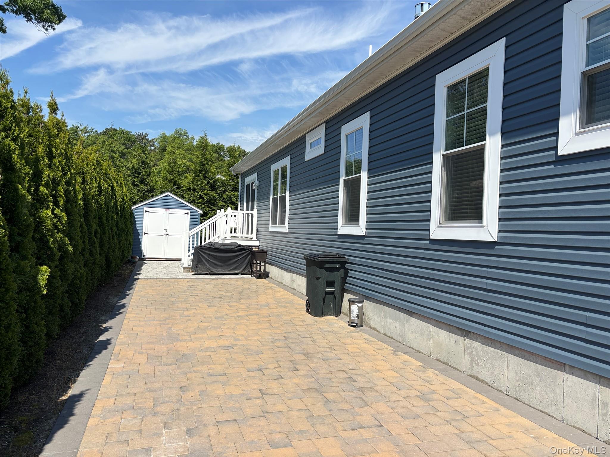 1661 Old Country Road, Unit 563 Riverhead, NY 11901 - Photo 3 of 43 a view of a back yard of the house