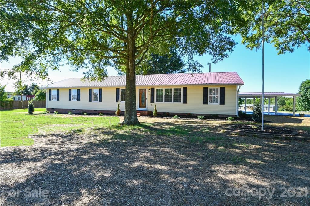 1119 West Sandy Ridge Road Monroe, NC 28112 - Photo 20 of 22 a view of a house with porch and garden