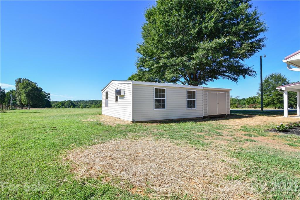 1119 West Sandy Ridge Road Monroe, NC 28112 - Photo 22 of 22 a backyard of a house with lots of green space