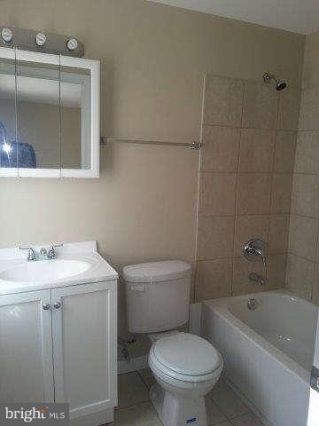 2121 Oak Road Edgemere, MD 21219 - Photo 8 of 8 a bathroom with a granite countertop toilet a sink and bathtub